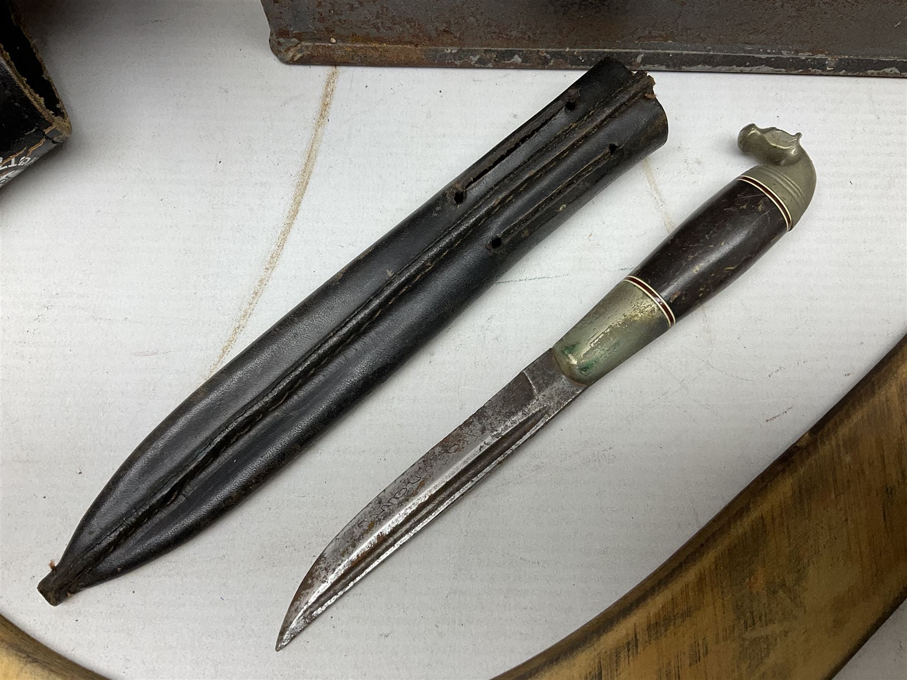 Assorted militaria including ten leather or canvas cartridge and other belts, maroon beret with 17th Lancers cap badge, modern bullet mould, leather and brass shot flask, two knives, shell cases, boomerang etc; in tin deed box