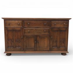 Ercol - elm dresser sideboard, fitted with four drawers and four cupboards with carved detail, drawer featuring cutlery slide