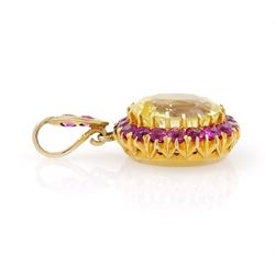 Gold yellow sapphire and ruby pendant, single cushion cut sapphire of approx 10.20 carat, surrounded by nineteen round cut rubies and ruby set bail
