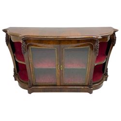 19th century rosewood buffet credenza, bombe form with shaped and moulded top, two central glazed doors with foliate moulded gilt slips, the red fabric-lined interior fitted with a single shelf, flanked by open shelves with raised gilt metal lips, the uprights decorated with shell and flower head carved cartouche mounts, acanthus leaf scroll carved lower mounts, on shaped and moulded plinth base 
