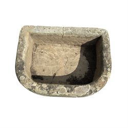 19th century hewn sandstone trough of D shaped form, in weathered finish