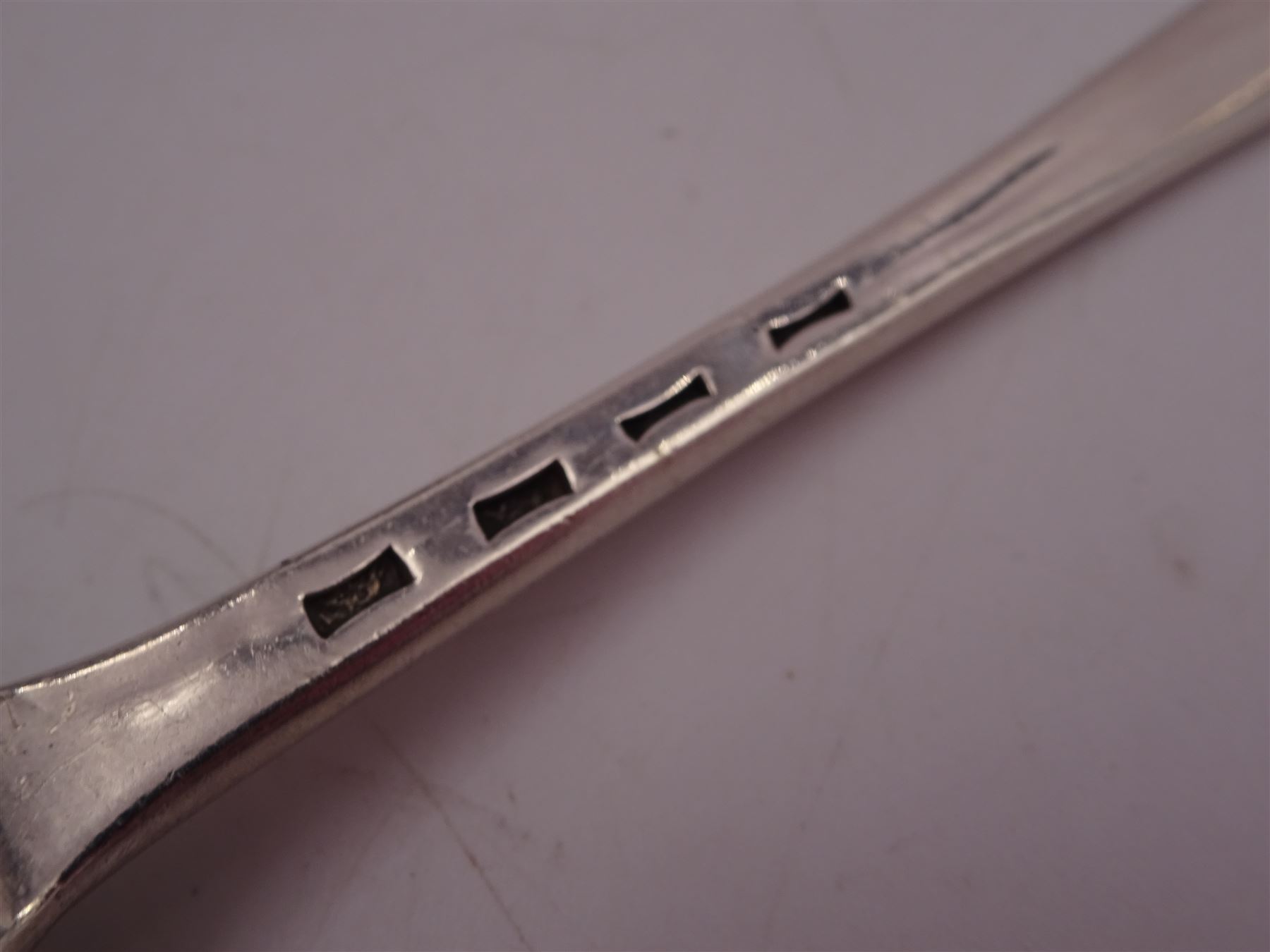 George IV silver fruit serving spoon, the bowl embossed with fruits, with engraved vine leaf decoration to handle, hallmarked London 1789, together with a very similar earlier example, hallmarks worn and indistinct