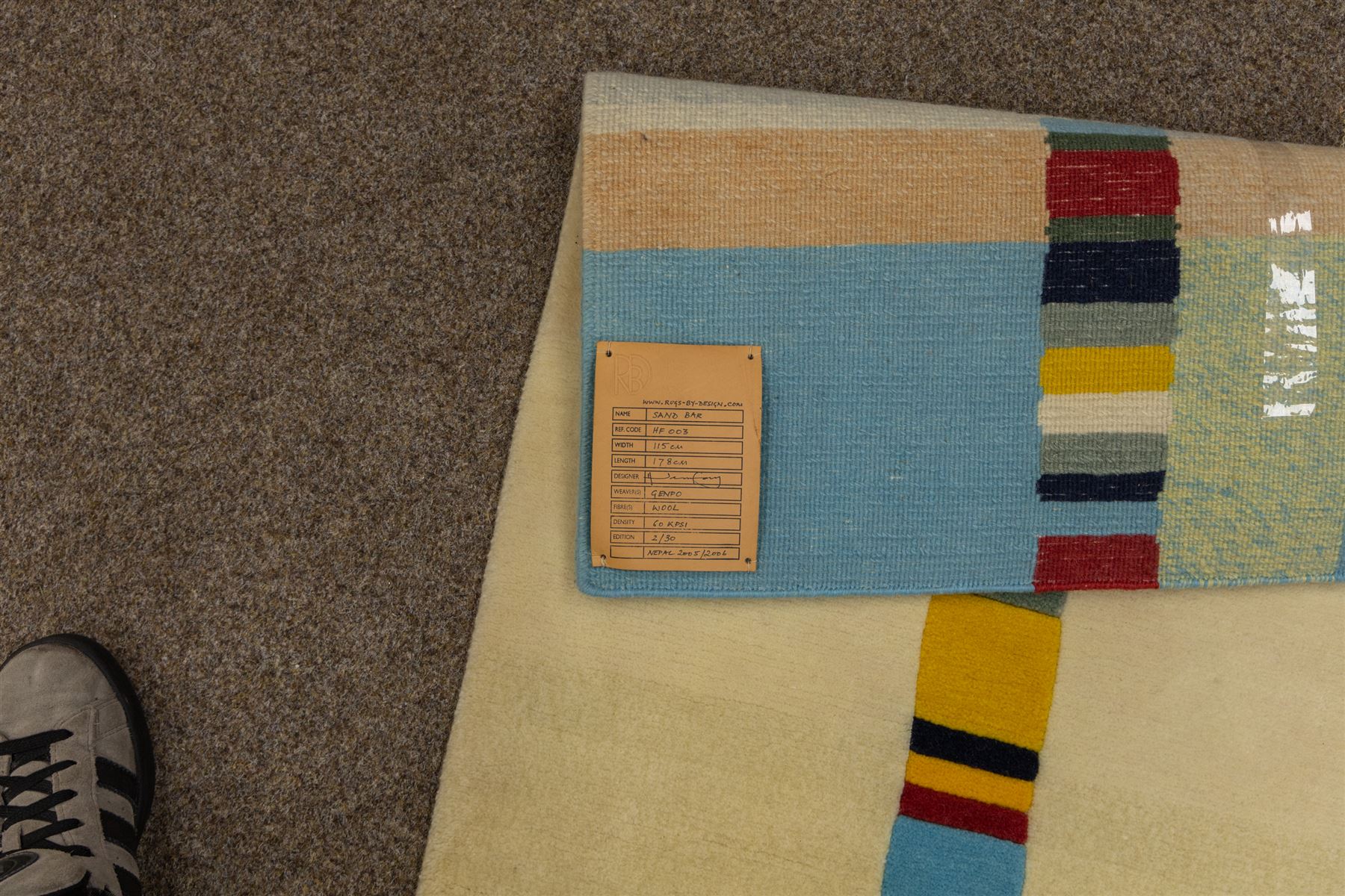 Rugs by Design - ‘Sand Bar’ Nepalese thick pile wool rug, with abstract horizontal bands in cream, blue, camel and dark brown tones, centred by a narrow multicoloured vertical stripe