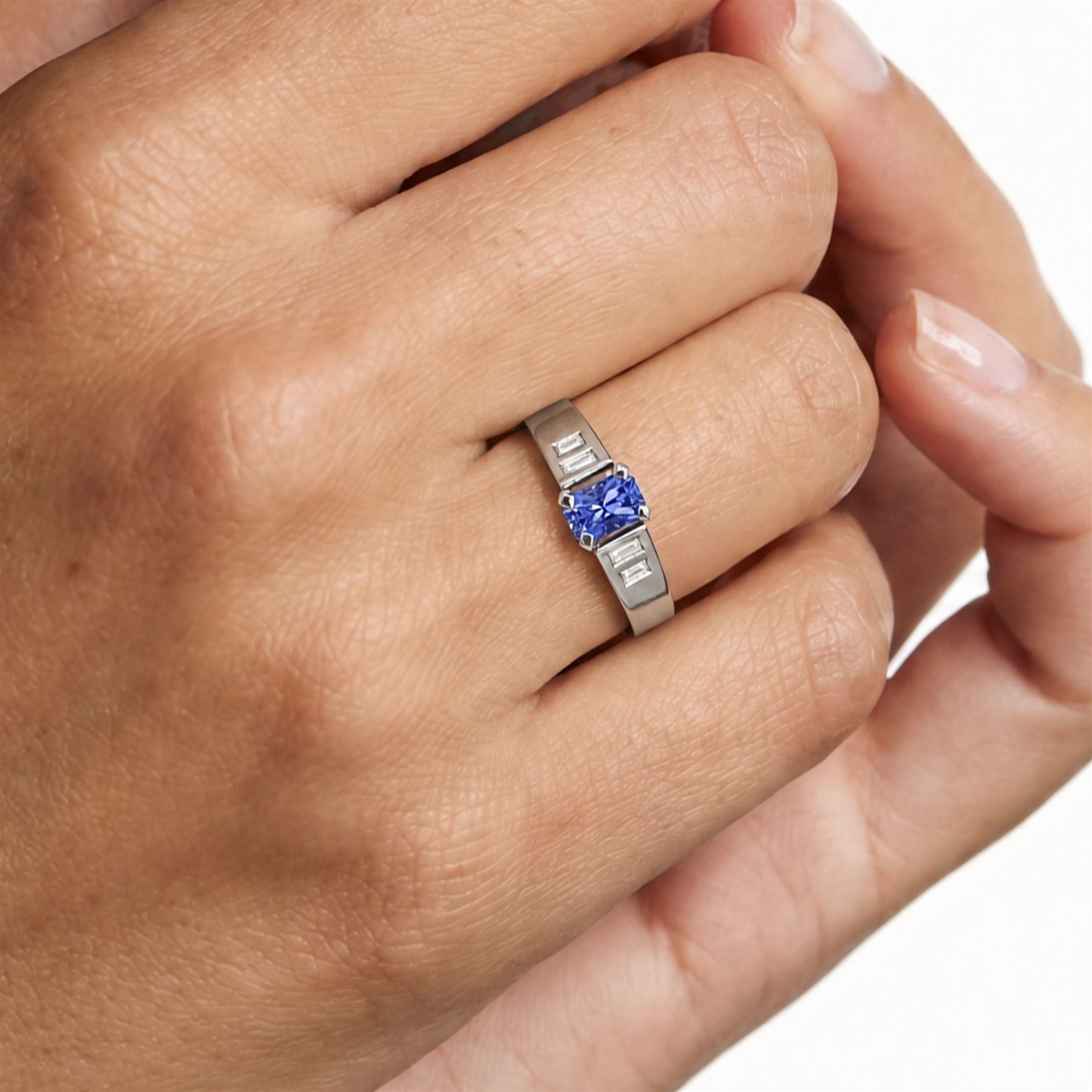 White gold sapphire and diamond ring, single stone radiant cut sapphire of approx 0.65 carat, with two baguette cut diamonds set either side, hallmarked 9ct