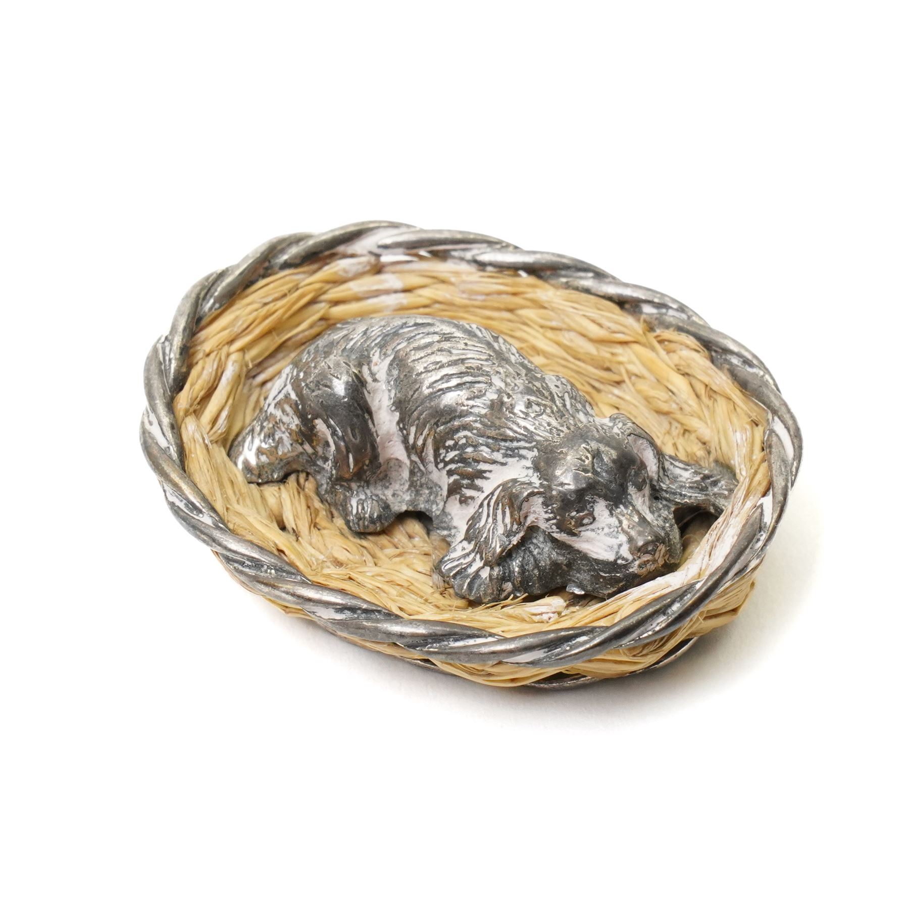 Silver model of a bird perched on a branch and with wooden base by Goldsmiths and Silversmiths Co. H5cm, small silver model of a pheasant on wooden base H2.5cm and a silver miniature model of a dog in a basket marked 925 and indistinct maker's mark L3.5cm (3)