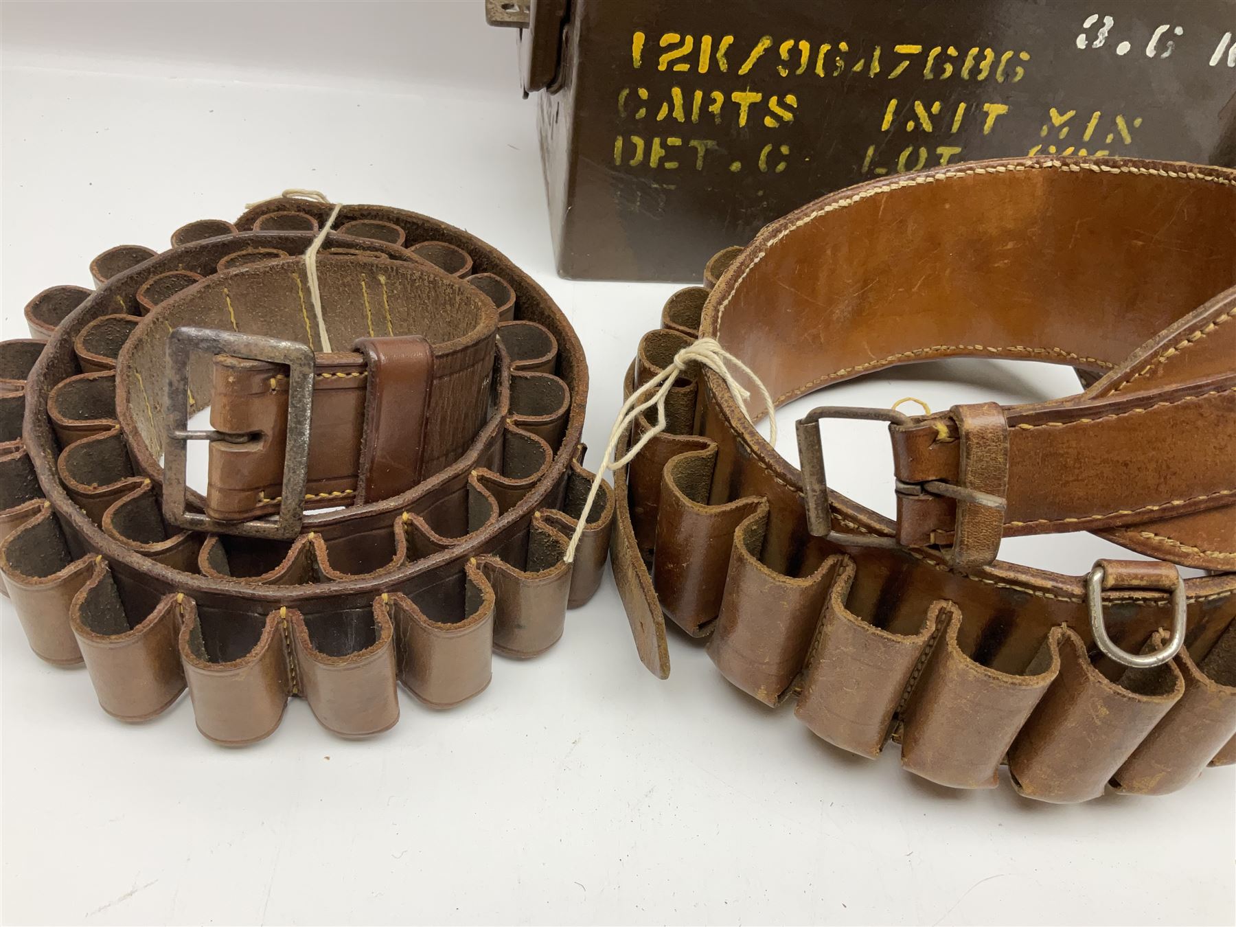 Miscellaneous shooting accessories - W.J. Bowman & Sons clay pigeon launcher; two leather cartridge belts; three cartridge bags; two canvas/leather game bags; and two metal/wooden cartridge boxes