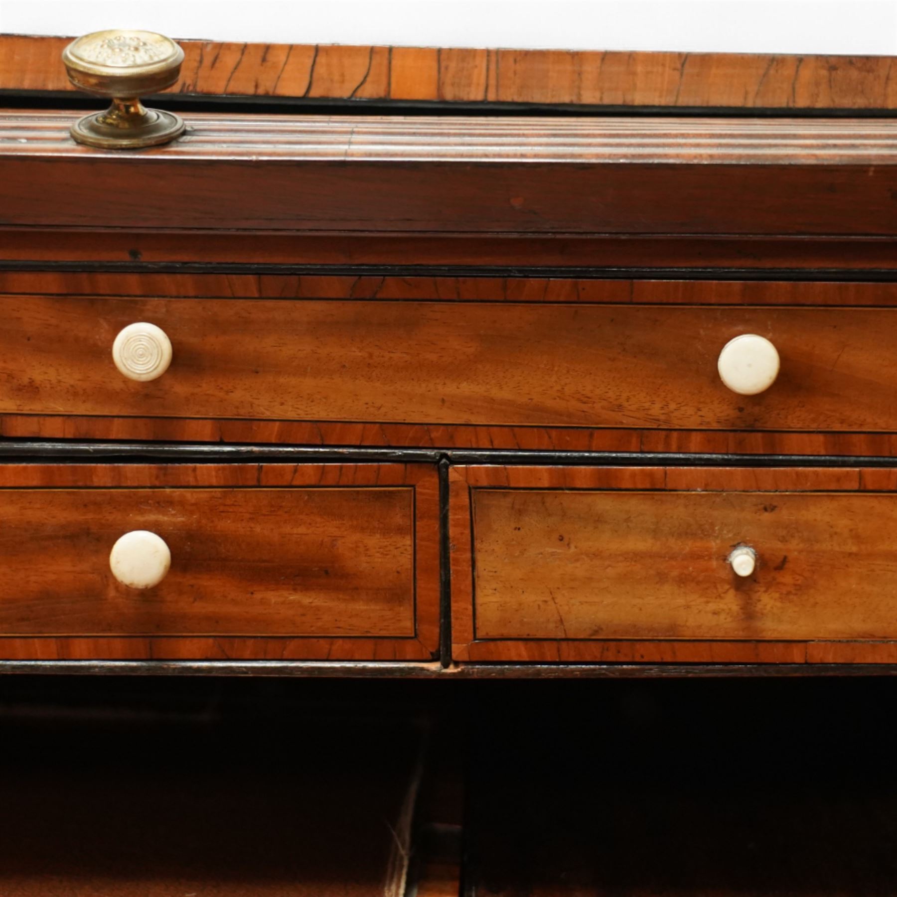 George III mahogany cylinder front writing desk, the hinged tambour enclosing pigeonholes and drawers with bone handles, sliding writing surface with leather inset, three frieze drawers below, on square tapering legs with brass caps and castors