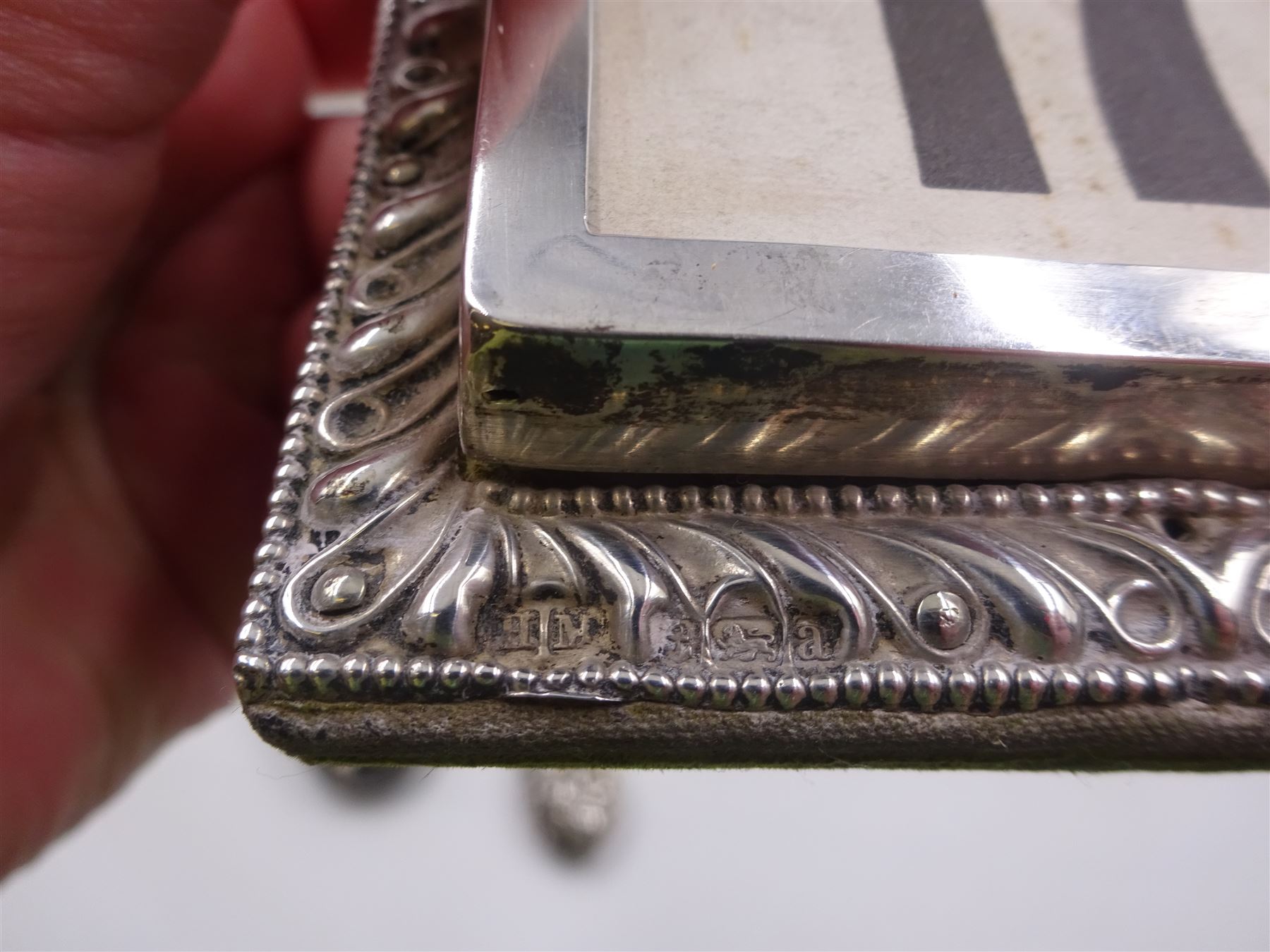 Group of silver, comprising Victorian silver mounted perpetual calendar with various date cards, hallmarked Henry Matthews, Birmingham 1900, silver mounted dressing table items, to include hair brush, with embossed decoration, pair of clothes brushes, and a shoe horn, together with a pair of silver mounted dwarf candlesticks, four cut glass jars/scent bottles with silver covers and a cut glass open salt with silver collar, all hallmarked 