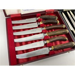 Set of six stag horn handled knives by Cooper Brothers and Sons, together with a set of silver plated dessert knives and forks for six place settings, both within fitted cases