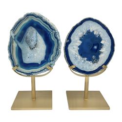 Pair of blue agate slices, polished with rough edges raised upon gilt metal stands, H22cm