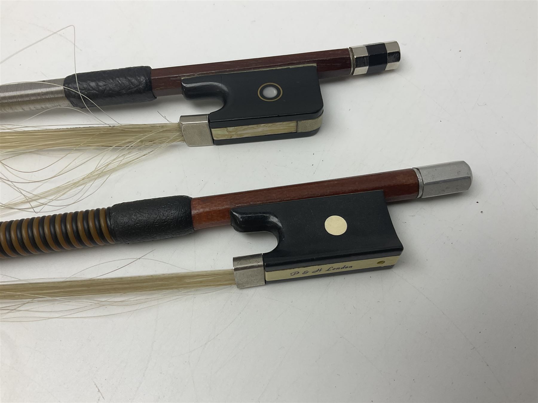 Two student half-size cellos - Boosey & Hawkes Artia with 65cm one-piece back and spruce top; bears maker's label; L104cm overall; and Romanian with 65.5cm two-piece maple back and ribs and spruce top; bears label; L108.5cm overall; each in soft carrying case with two bows (2)