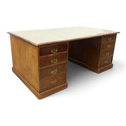Edwardian mahogany office desk, recatangular top with green inset leather writing surface, fitted with two banks of four drawers, brass swan neck handles with ornate backplates