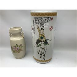 Oriental cylindrical stick stand, decorated with an elder with a tiger and a boy riding a bull , together with a twin handled vase decorated with gilded birds and flowers