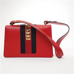 Gucci - ‘Sylvie’ Small Shoulder Bag, introduced circa 2016 under Alessandro Michele, in red calfskin leather with signature web stripe, gold-tone chain and buckle fastening and hardware, flat leather shoulder strap with alternative web-stripe grosgrain strap, unused with original dust bag