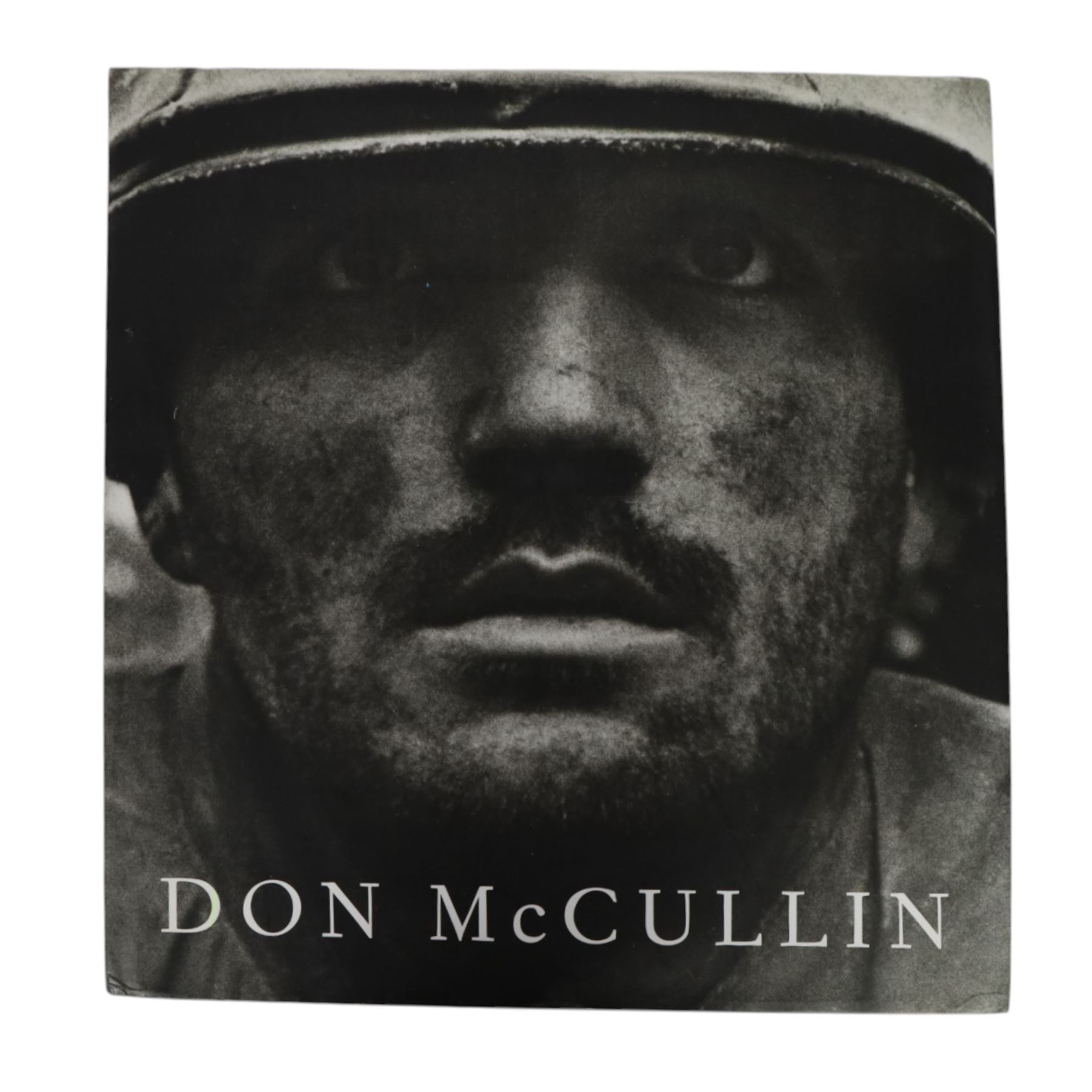 McCullin, Don: three hardback books, comprising 'Shaped by War', 'Hearts of Darkness' and a self titled example, together with a framed Times magazine cover depicting the photographer in black and white, signed to the left hand side