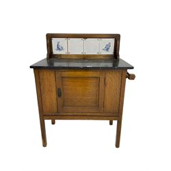Edwardian oak washstand, raised back with tiles and marble top, fitted with single panelled cupboard door
