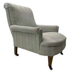 Late Victorian Howard design armchair, rolled cresting rail over sprung back and seat, upholstered in striped neutral fabric, on square tapering supports with brass and ceramic castors