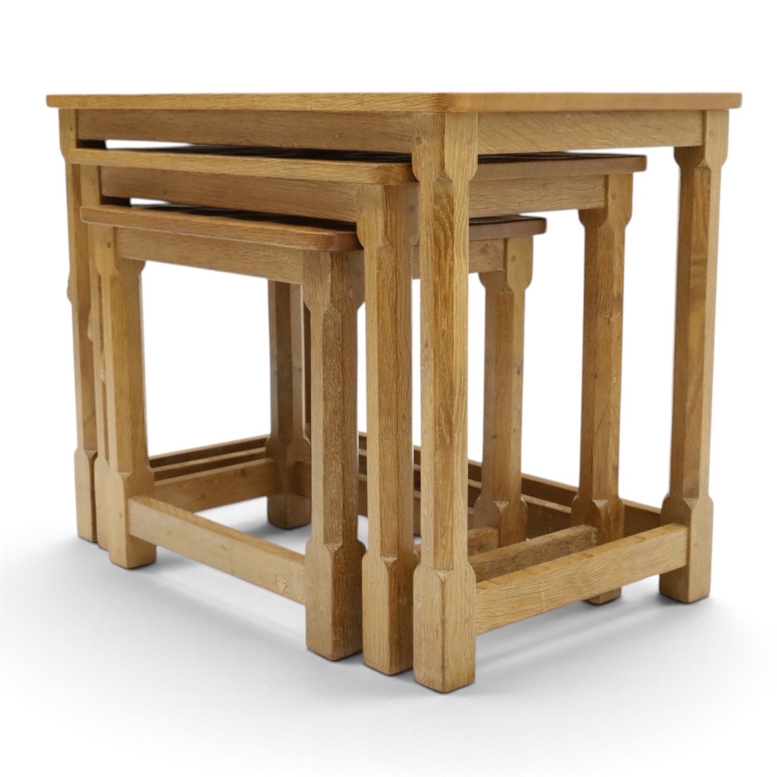 Mouseman - nest of three oak occasional tables, rectangular adzed top, on octagonal supports united by plain stretchers, each carved with mouse signature, by the workshop of Robert Thompson of Kilburn