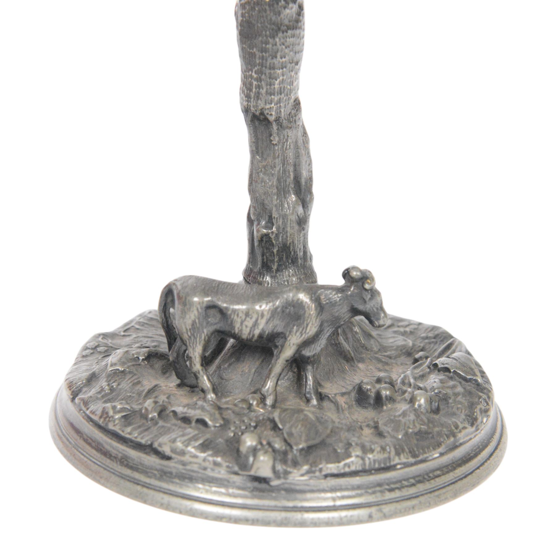 19th century silver plated desk holder, the circular naturalistically modelled base cast with fruiting vines and with applied figure of a ram, rising to a vine with two leaves, and initialled brass clip, H18cm