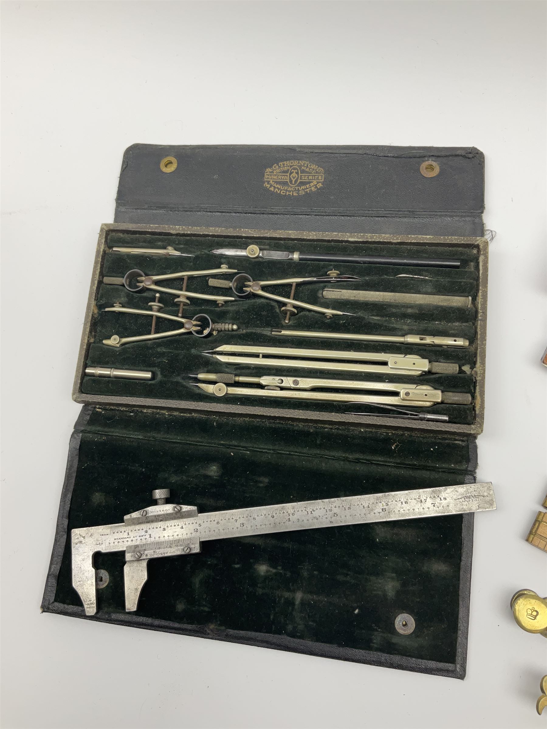 Two Victorian brass sovereign scales, one marked 'Harrison' L10cm; cased set of drawing instruments by G. Thornton Limited Manchester; Chesterman No.770/1 steel vernier caliper; two boxwood rulers; cased slide rule; brass and boxwood rope/wire gauge etc