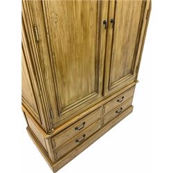 Polished pine double wardrobe, fitted with two doors above four drawers
