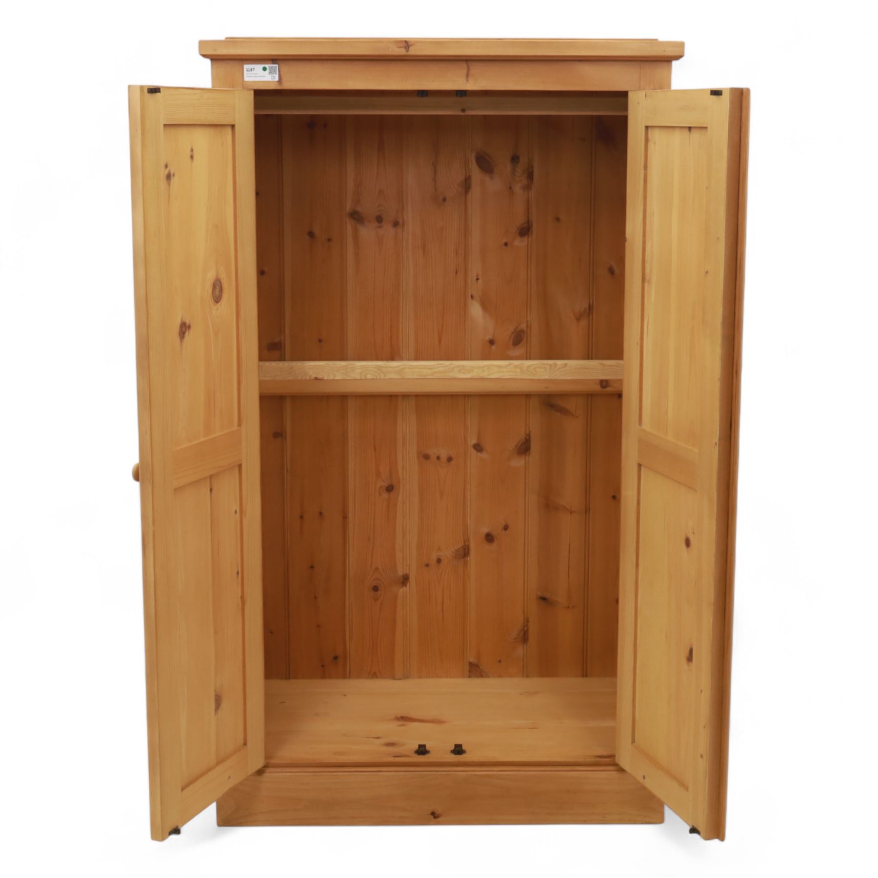Modern stripped pine two-door wardrobe, the fielded panel doors with turned knob handles, opening to a double rail hanging interior, beneath a stepped cornice and raised on plinth base