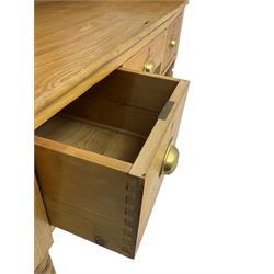 Early 20th century light oak kneehole desk, rectangular hinged top, fitted with frieze drawer flanked by two deep drawers, raised on ring turned supports