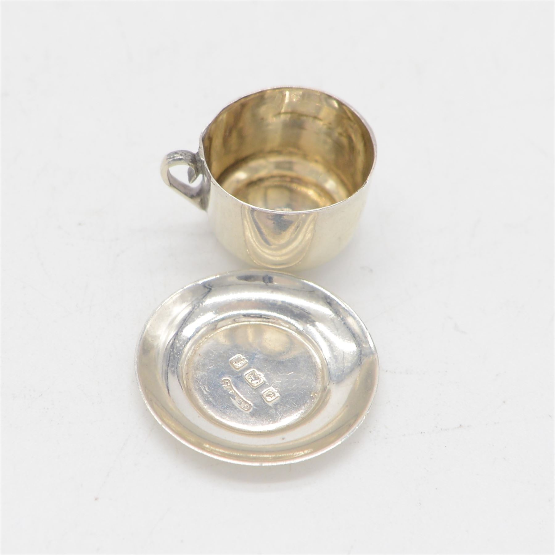 Edwardian miniature silver tea service, comprising tray, coffee pot, tea pot, milk and sugar bowl, all with engraved decoration, hallmarked J & J Maxfield Ltd, Sheffield 1903, together with a pair of miniature silver cups and saucers, hallmarked Cornelius Desormeaux Saunders & James Francis Hollings (Frank) Shepherd, Birmingham 1904, coffee pot H5cm