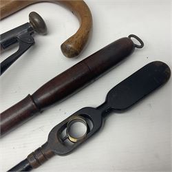 Two late 19th century fruit picker canes, the first example a French ebonised bamboo cane, with pair of fruit scissors to base, the handle stamped Cueille Fruit, the second example with grabbing action, the cap stamped A C Harris, Leicester, together with two other 19th century canes, one with fork and the other with hoe