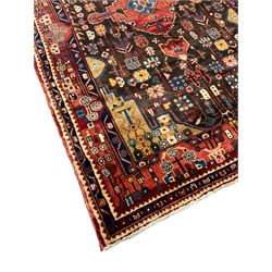 Persian Nahawand rug, central medallion in a field decorated with plant motifs, the guarded border decorated with flower heads and geometric motifs