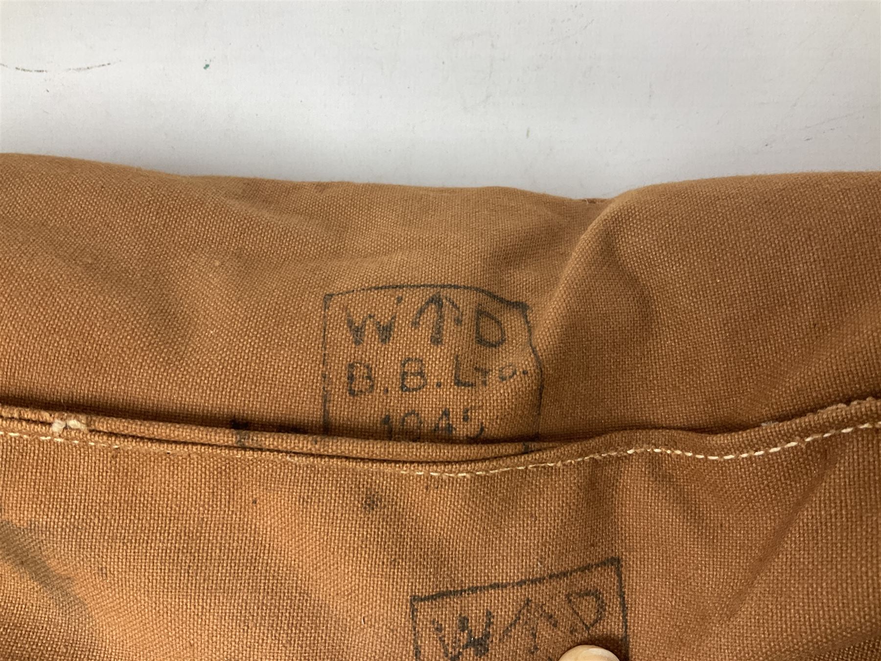 WW2 British Army RAMC 'Regimental Medical Pannier', well marked externally and dated 1941, stamped May 1943 internally, canvas covered wicker form with leather edges, hinged top and fall front with two rope carrying handles, fitted iron locking straps with securing chains; contains various unused field dressings and bandages with WW2 dates and two pillows; original label under lid L79cm