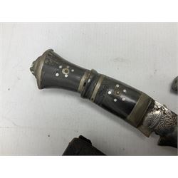 Indian kukri with 29cm curving steel blade and nickel mounted horn grip; in leather covered scabbard with one skinning knife L42cm overall; Hitler Youth knife with scabbard in relic condition; and three African graduated knives each with crudely carved wooden grips and painted leather covered scabbards (5)
