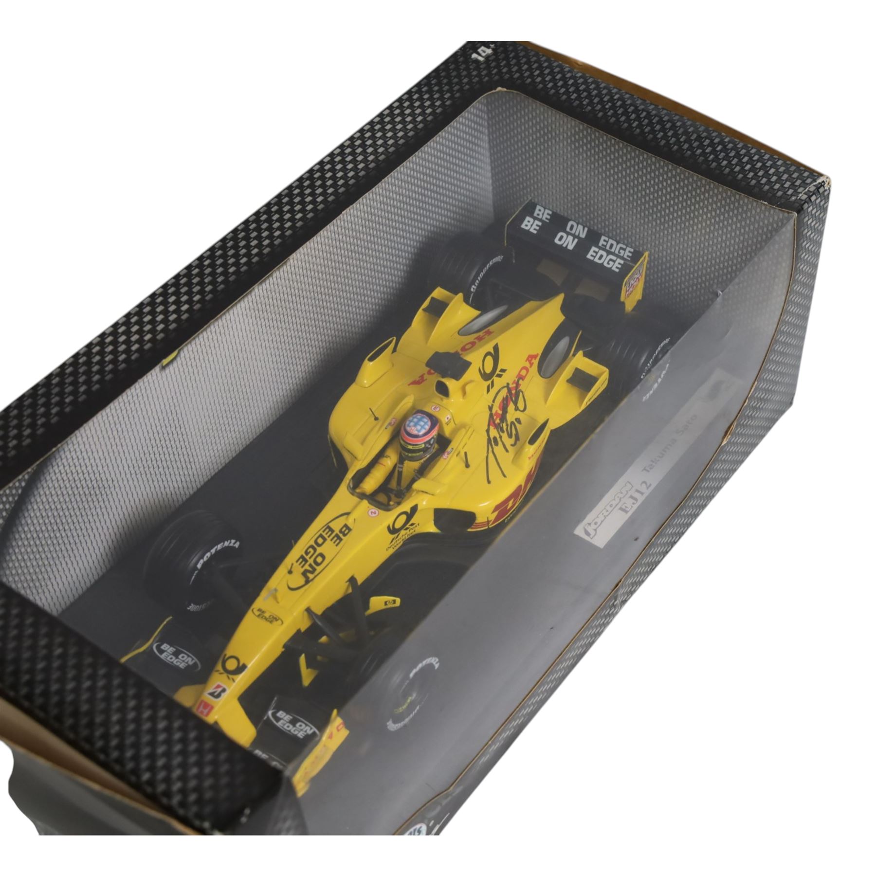 Three signed limited edition 1:18 scale Formula One models, comprising Hot Wheels Jordan EJ12 signed by Takuma Sato, Hot Wheels Jaguar Racing R2 signed by Eddie Irvine and a Minichamps Williams F1 Team model signed by Jenson Button, 1:18 scale model, all boxed