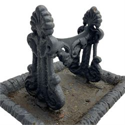 Cast iron boot scraper, raised supports with anthemion motifs and scrolled leaf decoration, rectangular dished base with foliate cast edge