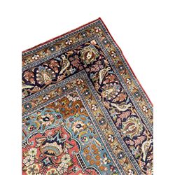 Persian Kashan peach ground rug, central rosette medallion surrounded by trailing branches and flower heads with bird motifs, light blue spandrels with further floral decoration, the main border with repeating palmettes and birds, within guard stripes