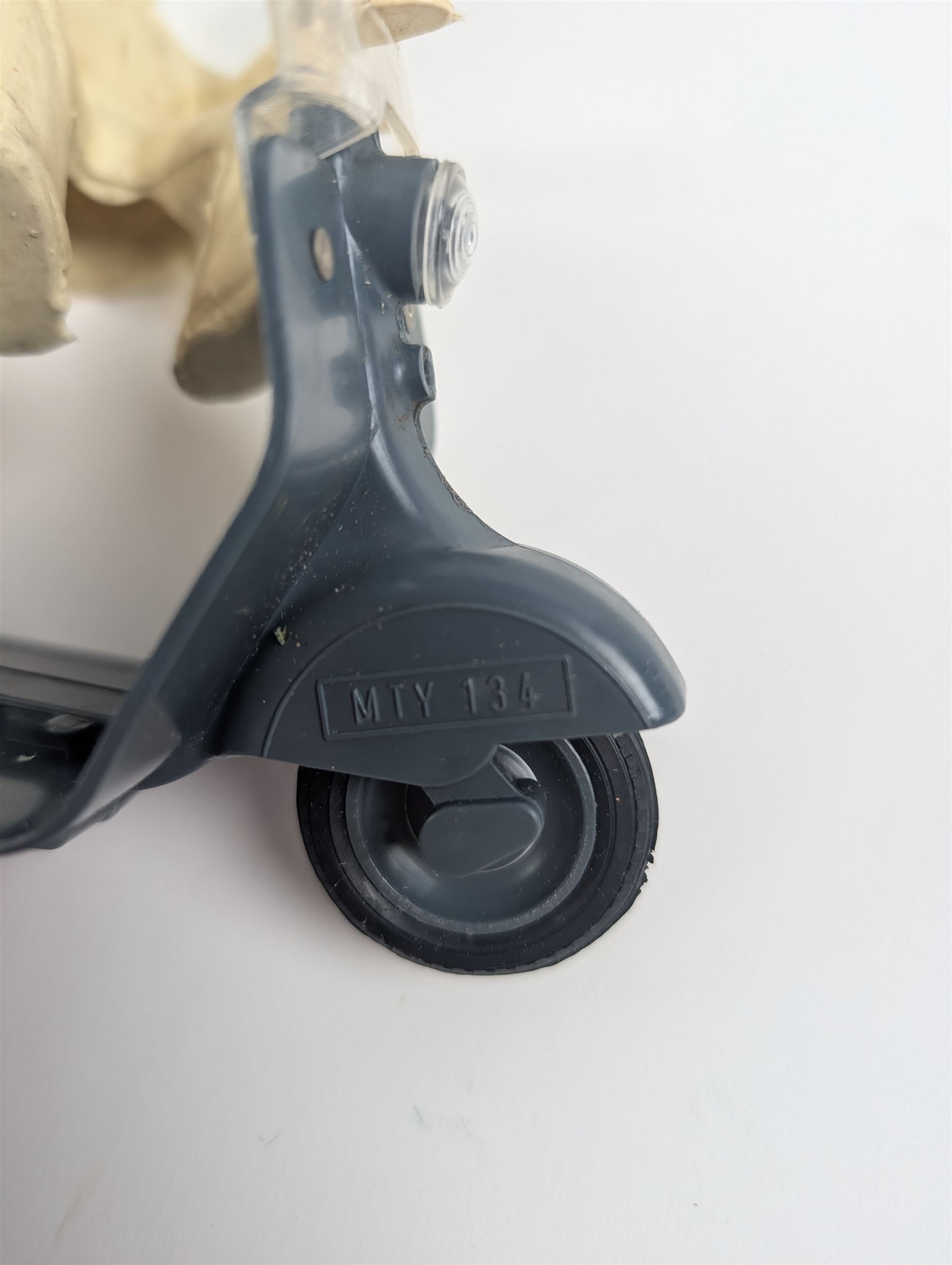 Mettoy friction drive Lambretta scooter no. 8134, the blue plastic scooter with cream handlebars and clear windshield, the rider with cream hat and clothing, stamped MTY 143 to front mud guards, in original box