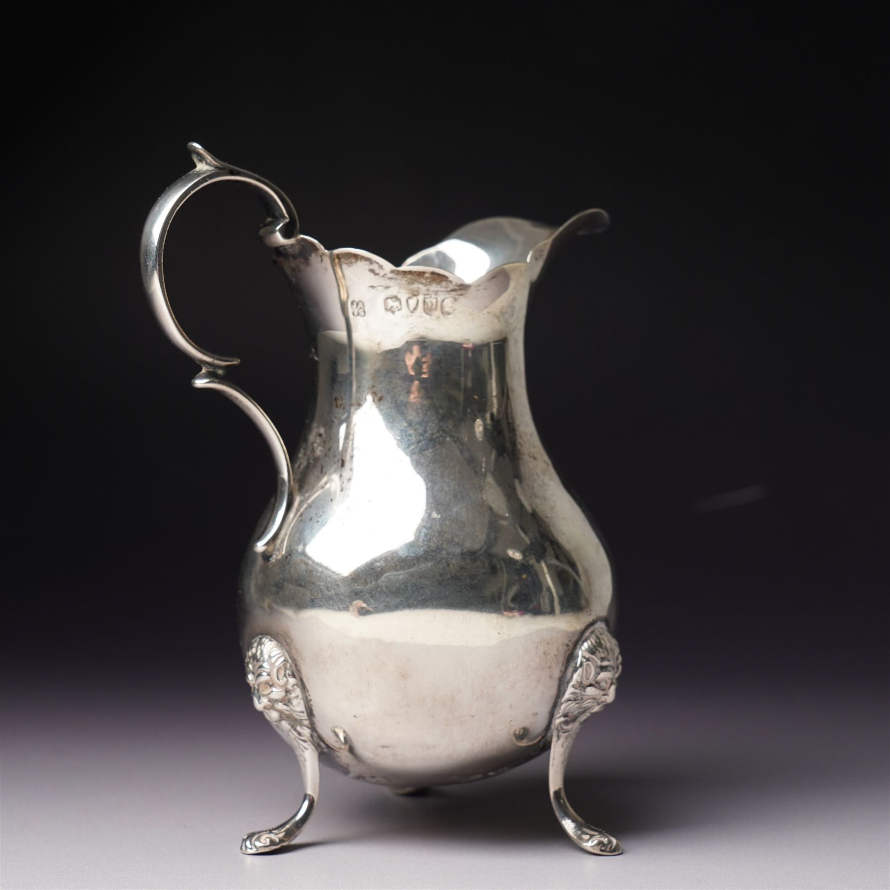 Victorian silver cream jug with crimped rim, scroll handle and lion mask supports London  1887 Maker John Aldwinckle and Thomas Slater