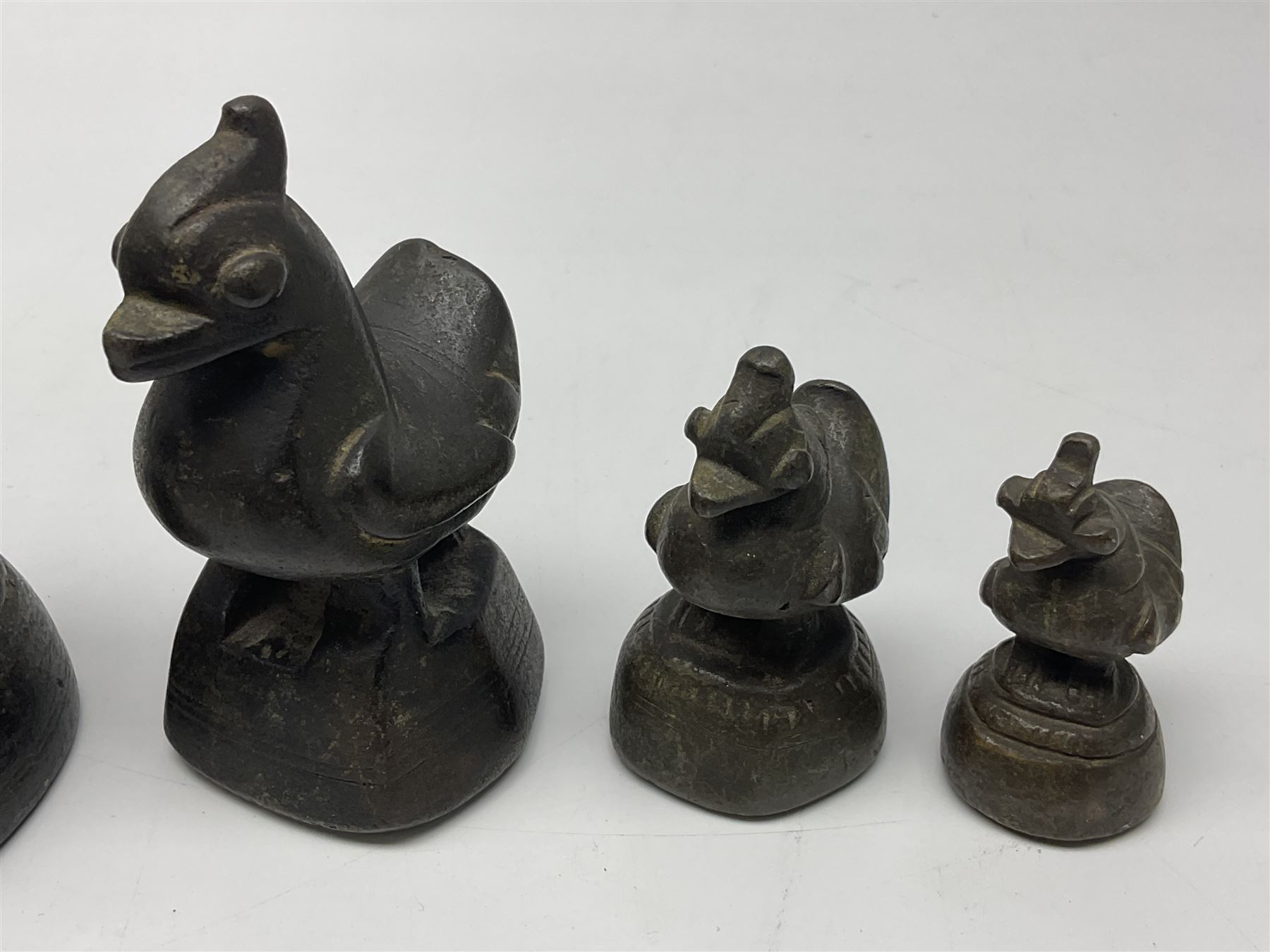 19th century graduating set of Burmese bronze opium weights, in the form of Hintha birds, tallest H11.5cm (8)
