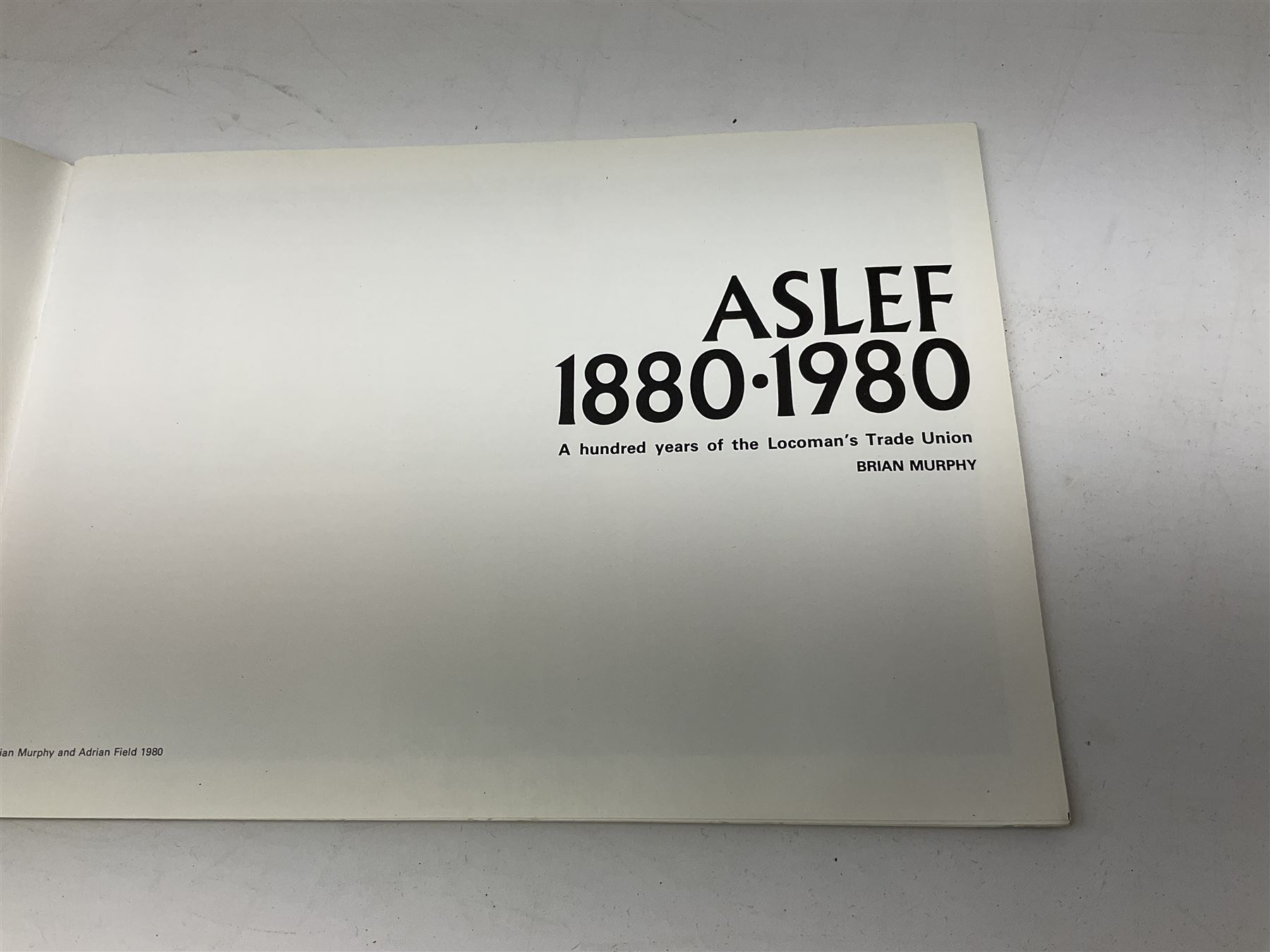Black painted three colour railway lamp with revolving filters, H29cm; BR Acme Thunderer whistle; three railway peaked caps, two with BR Intercity 125 badge; small album of photographs of railway interest etc