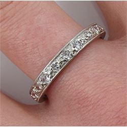 Early-mid 20th century platinum channel set diamond eternity ring, with milgrain border