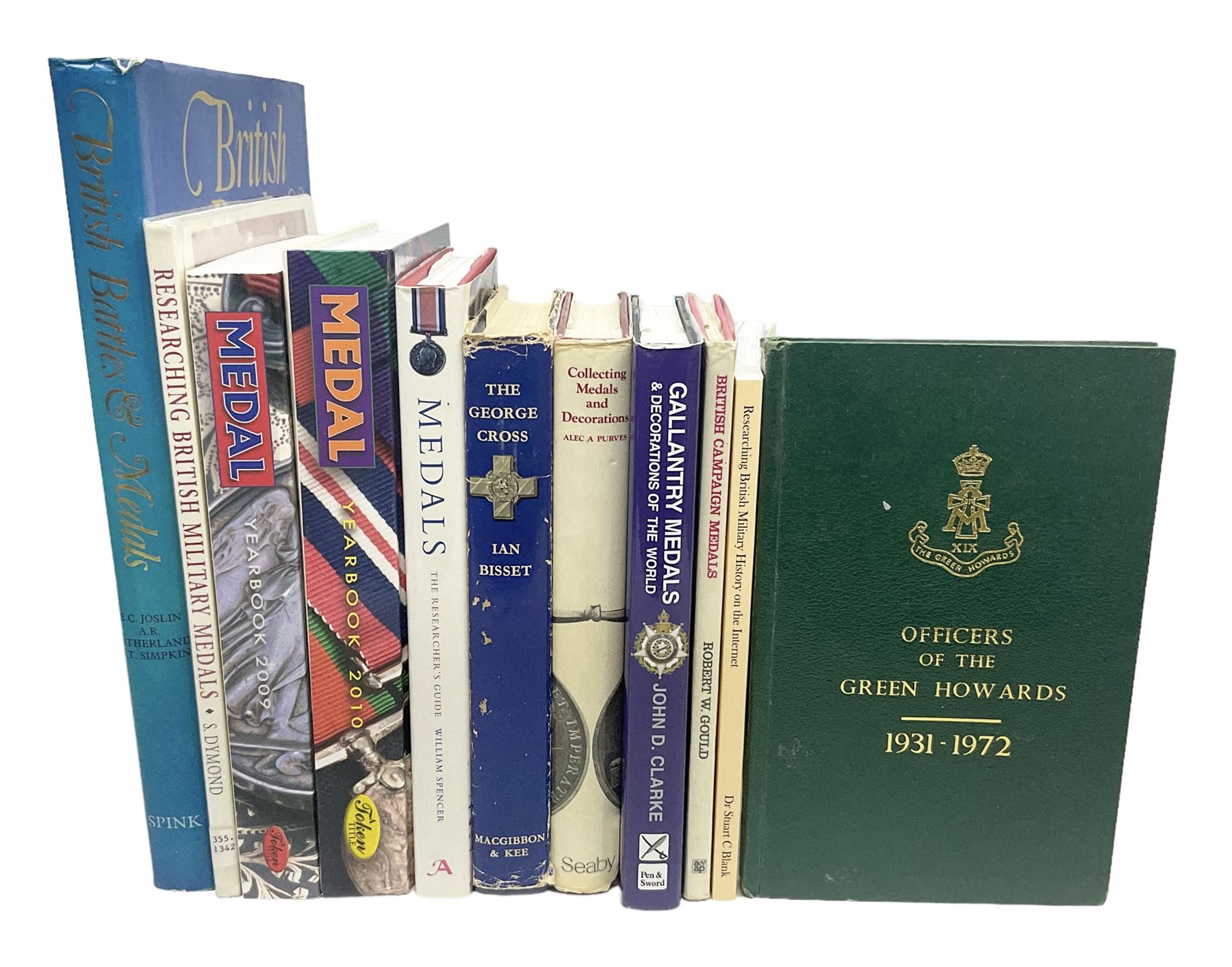Eleven medal reference books including Ian Bisset: The George Cross; Spinks British Battles & Medals; William Spencer: Medals - The Researchers Guide; John D. Clarke: Gallantry Medals & Decorations of the World; Officers of The Green Howards 1931-1972; and six others (11)