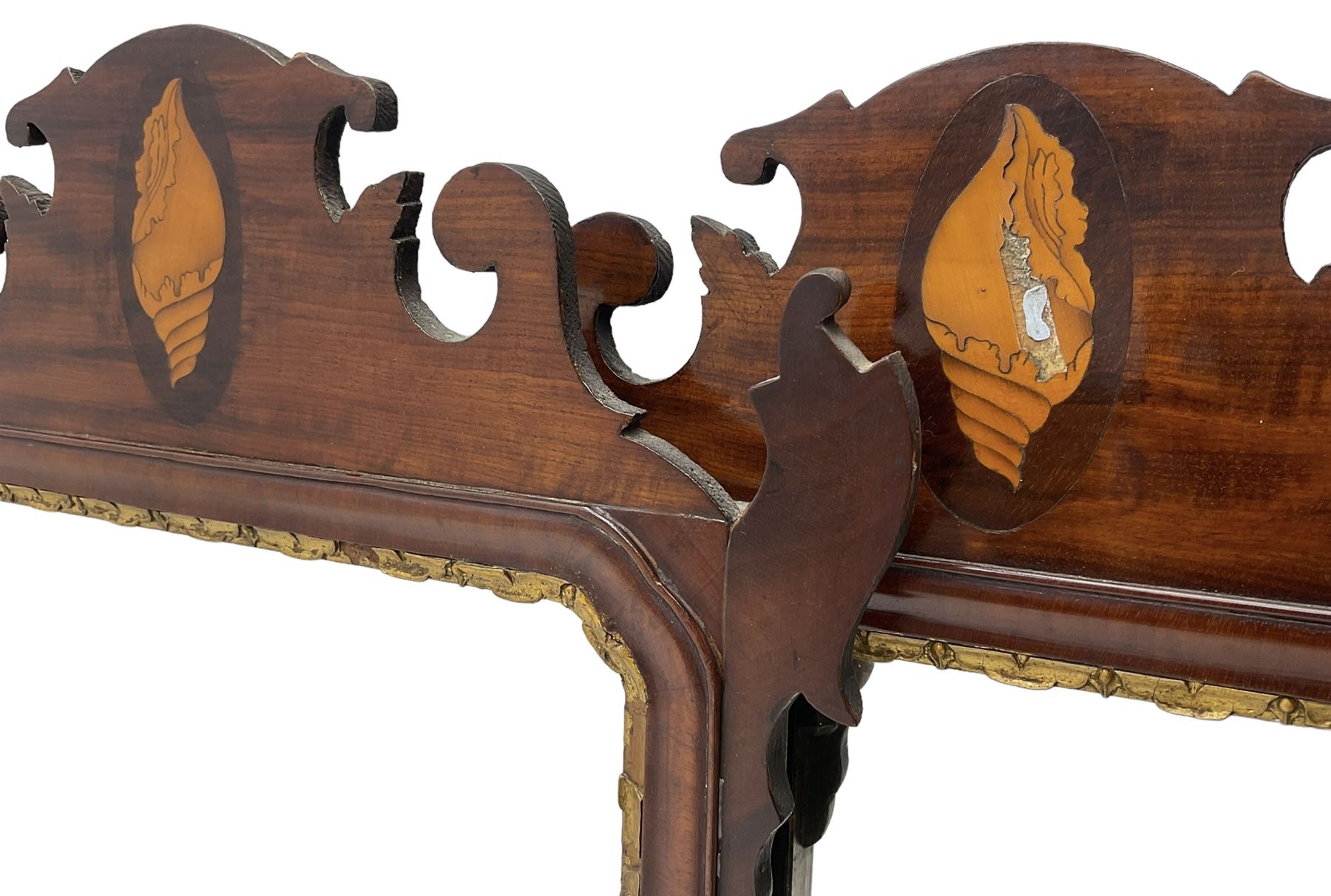 Pair of early 20th century Georgian Chippendale mahogany design wall mirrors, shaped pediment and terminal with shell motif inlays, rectangular bevelled plate within a foliate carved gilt slip