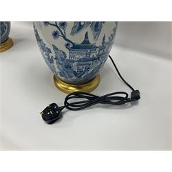 Pair of Chinese table lamps of baluster form, each decorated with landscape scene, raised upon gilt circular base, including shade H63cm