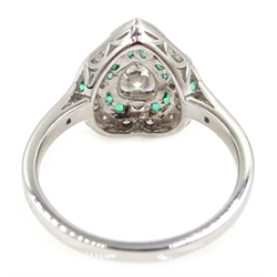  White gold heart shaped ring, central pear shaped diamond with emerald and diamond surround, stamped 18K, central diamond approx 0.7 carat  