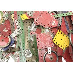 Meccano - wooden box containing a quantity of predominantly red/green playworn sections, pulley wheels, rods etc; together with a quantity of loose playworn sections, wheels etc in various colours