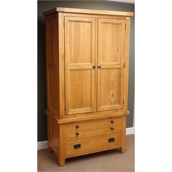  Light oak double wardrobe, projecting cornice, two panelled doors enclosing hanging rail above two drawers stile supports, W107cm, H198cm, D57cm  