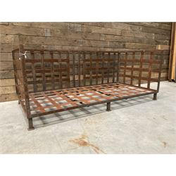 Wrought iron strapwork garden day bed, lattice back and sides