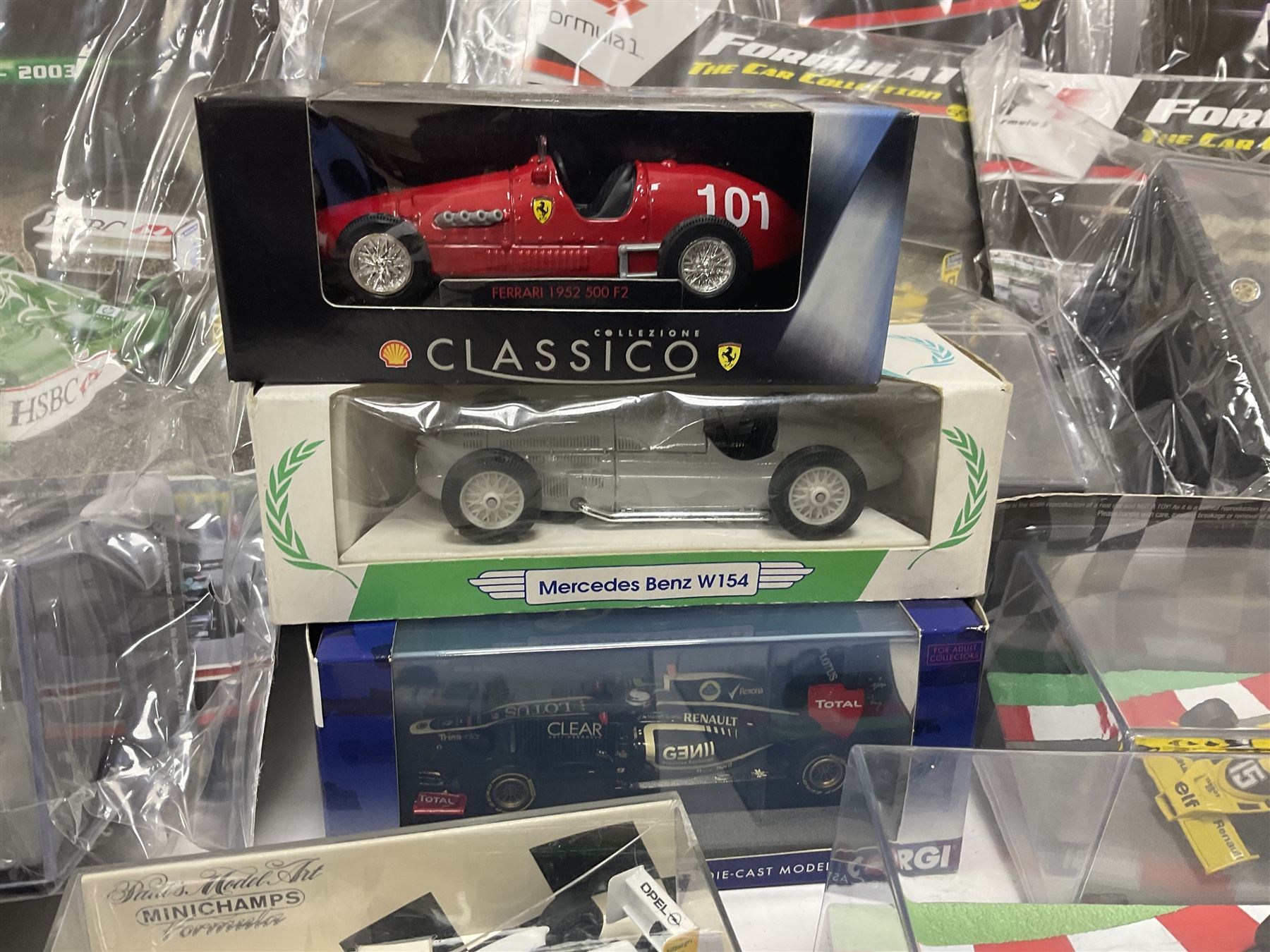 Panini Formula 1 The Car Collection - twelve die-cast models including ten in unopened packaging with periodical; all models in plastic display boxes; and eight other boxed die-cast models of racing cars by Corgi, Onyx, Classico, Minichamps etc (20)