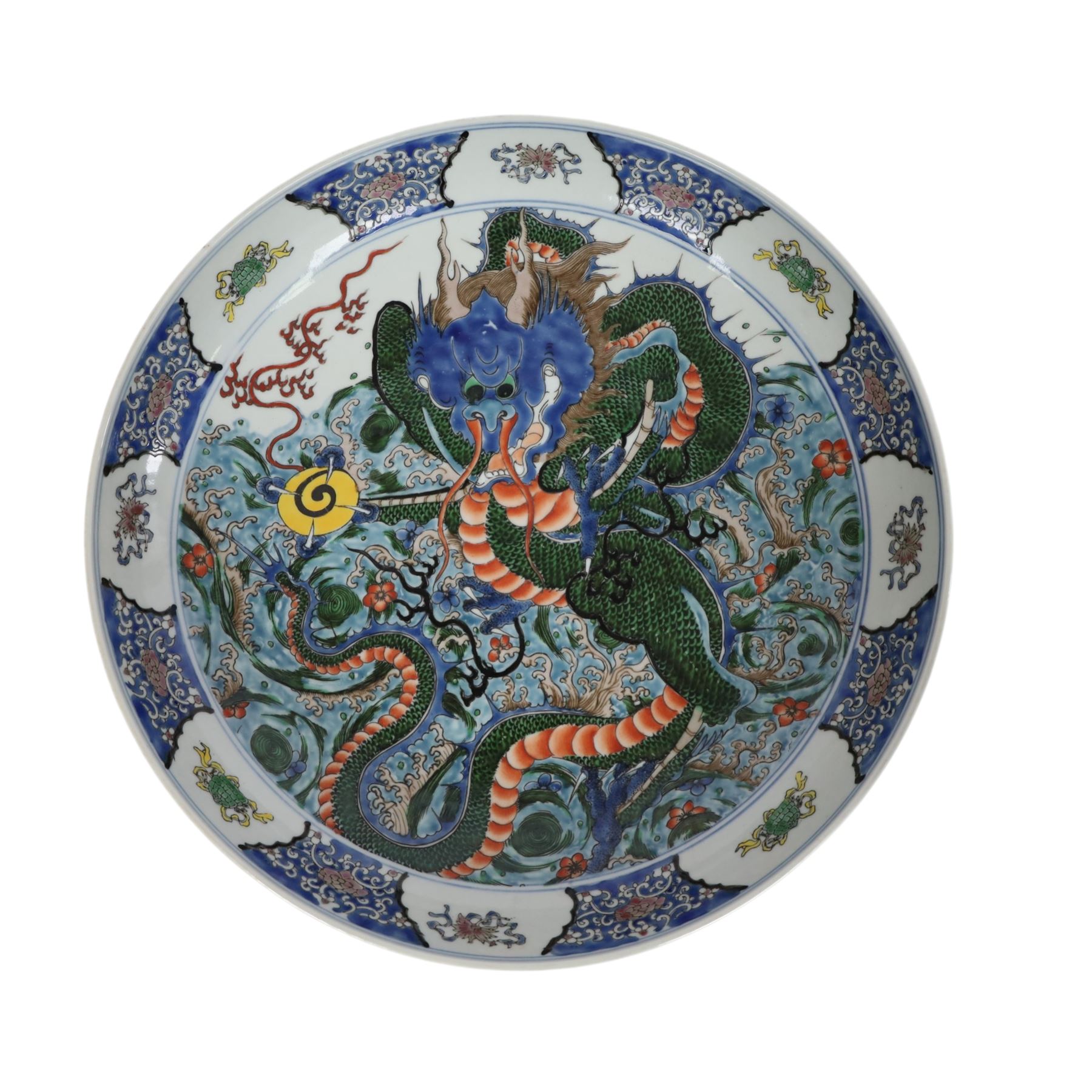 20th century Chinese charger, decorated in blue, green and red enamels with a four clawed dragon chasing the flaming pearl amidst waves and flower heads, the rim with border of alternating reserves of auspicious emblems and flower scrolls, bearing apocryphal Kangxi mark beneath, D38cm 

