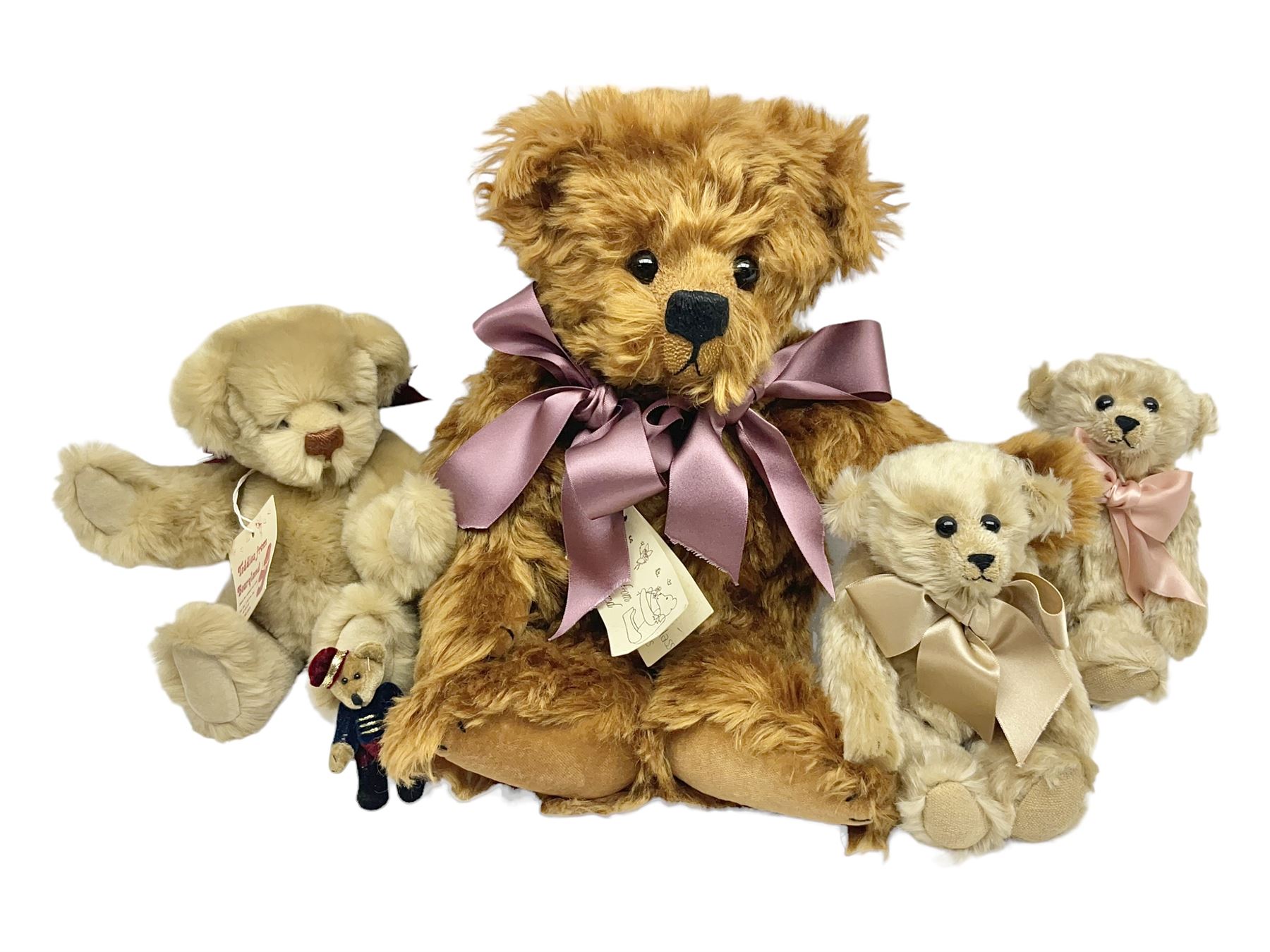Group of five teddy bears comprising ‘George’ a unique pellet filled bear with glass eyes and velvet paws H38cm, and ‘Abbey’ a luxury German plush with wobble head and glass eyes no.5/10 H24cm, both with Teddies from Bearyland labels; along with two light blonde mohair H. M. Bears and Boyds Bears ‘T. F. Wuzzies’ no. 595140 (5)